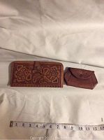 Photo of wallet and change purse side by side showing length with ruler for scale