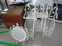 Shows wooden 3-tier sewing box with contents and three white metal toilet roll holders, plastic framed mirror on floor.