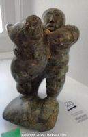 Front view of hunter holding walrus, showing overall form and color