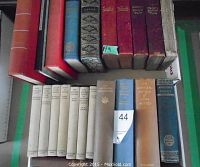 Lot of vintage hardcover books seen from above showing variety and condition