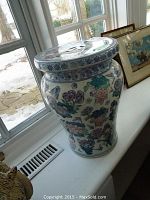 Side view of Chinese porcelain garden stool showing floral design and shape.