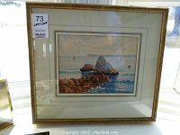 Framed watercolour painting showing entire coastal scene artwork and frame with tag #73