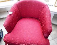 Top front view of the red brocade fabric tub chair upholstery, highlighting pattern and cushion shape
