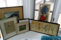 Overall view of the 5 framed prints leaning on a window ledge, showing variety in style and size with some water staining visible.