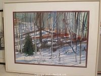 Front view of framed watercolor painting depicting snowy forest with birch trees, white frame and mat