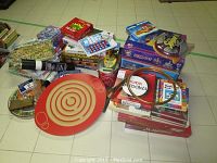 Overview of assorted board games including Scrabble, Backgammon, Sudoku, Monopoly, Sorry, puzzle games, playing cards, dominoes, and a red round 3D labyrinth maze game.