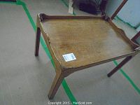 Full view of the wood occasional table showing the rectangular shape, raised edges, and overall condition.