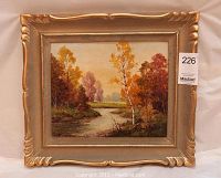 Frontal view of the framed painting showing autumn landscape with river and colorful trees.