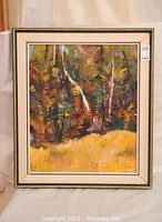 Full view of the framed vintage oil painting showing the landscape scene with trees and foliage in autumn colors.