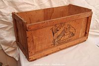 Crate angled showing side panel with printed Victor logo and dog graphic.