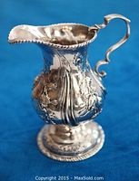 Creamer upright on blue cloth, full view