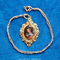 Front view of pendant and chain on blue background