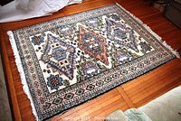 Full view of rug laid flat on hardwood floor