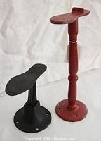 Both shoe lasts together showing their relative size and material difference