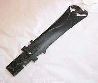 Full-length view of flat jade blade showing overall shape and color