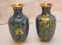Pair of vintage blue cloisonne brass vases showing frontal and partial side views with floral enamel decoration