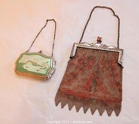 Silver plated Art Deco compact with green and cream Chinoiserie enamel decoration next to mesh evening bag with painted orange and black pattern