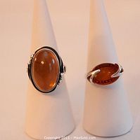 Front view of both amber rings displayed on ring cones