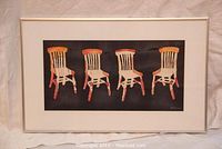 Full framed artwork showing four stylized chairs in red and orange on a black background, signed by Judith Livingstone.