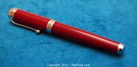 Full length photo of the red Aurora Talentum fountain pen showing its sleek cylindrical red barrel with silver trim and clip.