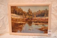 Framed impressionist landscape painting showing entire artwork with light wood frame and reflective water body among trees.
