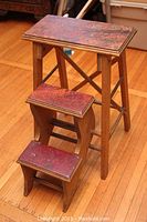Side view of the three-step wooden step stool showing original stain and painted step surfaces.