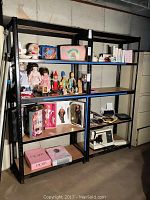 View of two black metal shelving units with various items placed on MDF wood laminate shelves.