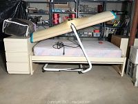 Vintage tanning bed, beige with curved top, power cord, and ventilation fan seen from side and angled top.