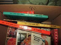 Top view of box showing spines of Better Cooking Library cookbooks including Cookie Cook Book, Salad Book, Dessert Cook Book