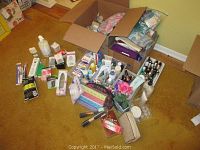 Wide view of personal care items spread on carpet with boxes and containers