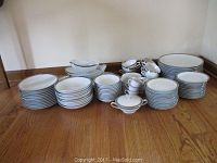 Full view of the Noritake Silvester china items arranged on floor showing plates, bowls, cups, saucers, sugar bowl, and creamer.