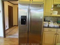 Front closed view of refrigerator showing stainless steel finish and dispenser