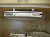Sony under-cabinet radio CD player mounted under cabinet, showing digital clock display and buttons