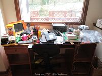 Image showing entire desk with multiple vintage and office items including electronic devices, stationary, and personal care items.