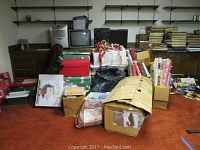 Overall assortment of boxes, wrapping paper and packaged items on basement floor