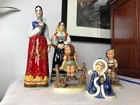 Photo showing all five figurines together including three Hummels and two Italian ladies.