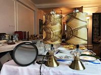 Two table lamps with bronzed metal bases, crystal inserts and fabric shades with brown swirled design. Also includes round magnifying mirror on articulating arm, black framed.