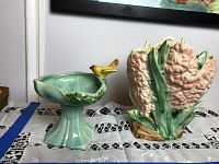 View showing both McCoy ceramic items: floral vase and birdbath dish with bird