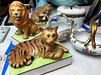 Photo showing lion music box, tiger music box, leopard figurine, and three porcelain floral candy baskets