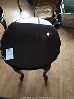 Top view of the dark-stained solid wood side table showing glossy finish and scalloped edges.