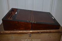 Open lap desk showing replaced leather writing pad, wooden dividers including small drawers and pen storage grooves.
