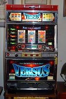 Overall frontal view showing illuminated marquee, logo, reels and base.