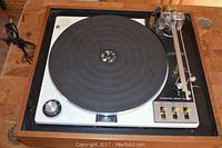Full top view of the vintage Garrard Zero 100 turntable showing the platter, tonearm, and wood casing.