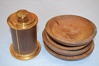 Photo of vintage cigarette dispenser and four primitive wooden bowls side by side.