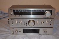 Front view of the three component Aurex stereo system stacked, showing all control panels and tuning dial, with minor cosmetic wear.