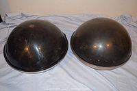 Two black dome-shaped covers for Apollo 860 record players, showing surface wear and some scratches.