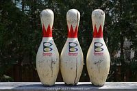 Front view of the 3 Brunswick bowling pins, showing the red crown design and Brunswick logo.