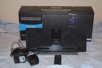 Sirius Stiletto Executive System with remote and power adapters shown in front of product box.