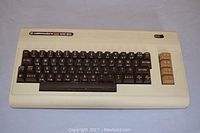 Full view of the Commodore VIC 20 keyboard showing its beige casing and brown keys.