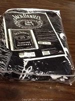 Photo of Jack Daniels branded blanket throw in its original packaging, displaying brand and size information.